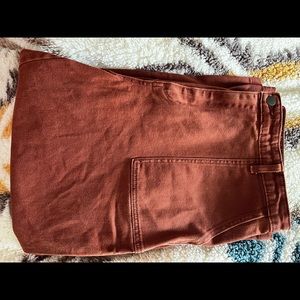 Really hip, high waisted rust colored jeans.